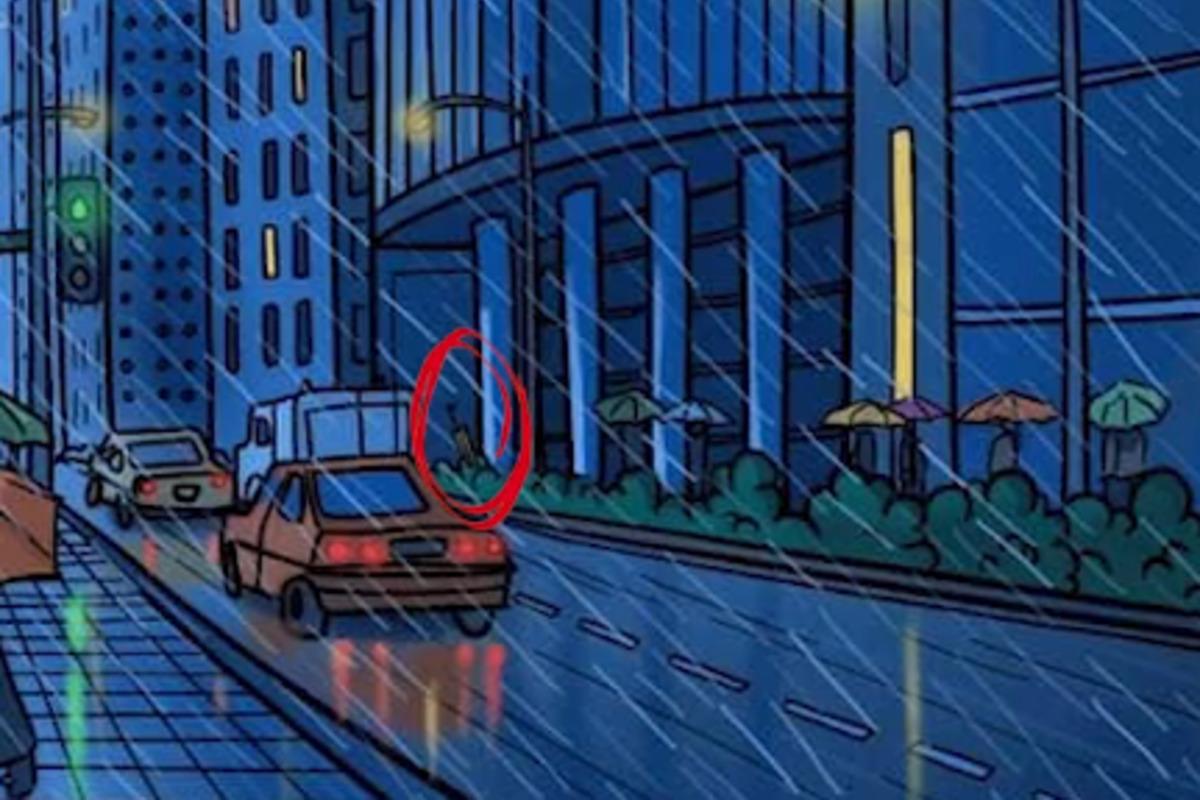 Obrazek z zaznaczonym na czerwono ukrytym parasolem, który okazuje się być ozdobnym daszkiem nad oknem na elewacji budynku.